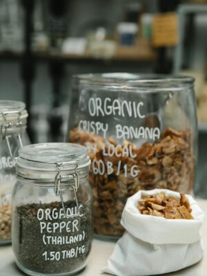 Glass jars and cloth bag filled with organic food, showcasing sustainable packaging in retail.