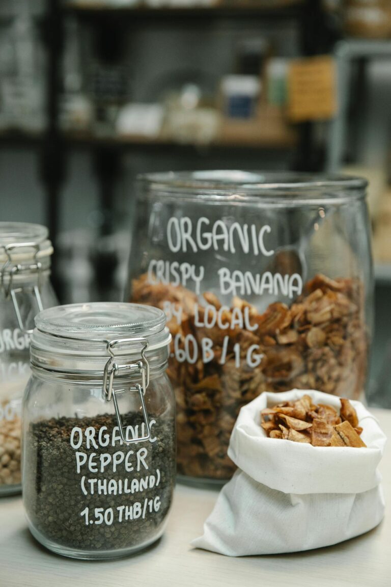 Glass jars and cloth bag filled with organic food, showcasing sustainable packaging in retail.